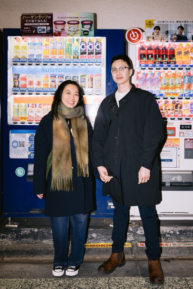Couple in front of vending machines at night in Shinjuku